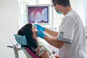 Dentist viewing dental implant patient's teeth