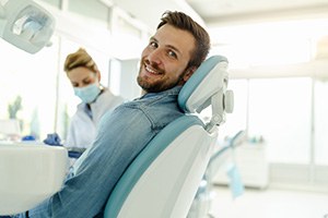 Man smiling while sitting in treatment chair