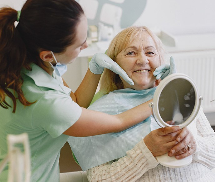 Dental team in Matthews evaluating a patient's new dentures