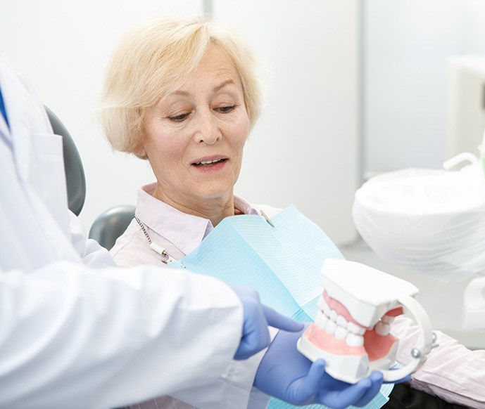 Dentist talking to patient about different denture types