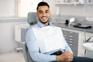 Patient smiling while sitting in treatment chair