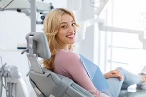 Woman smiling while sitting in treatment chair