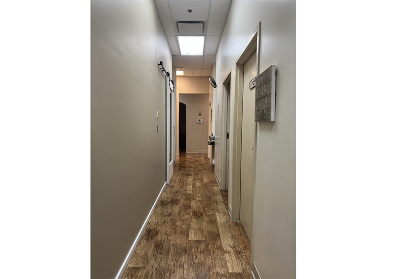 Hallway at dental practice with doors leading to treatment areas