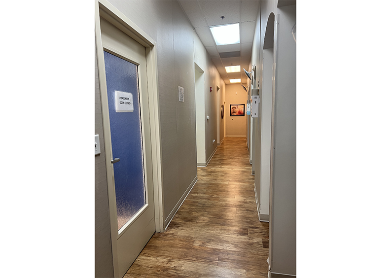 Hallway at dental practice with doors leading to treatment areas
