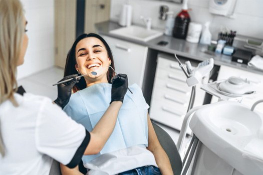 Patient smiling during dental checkup and cleaning