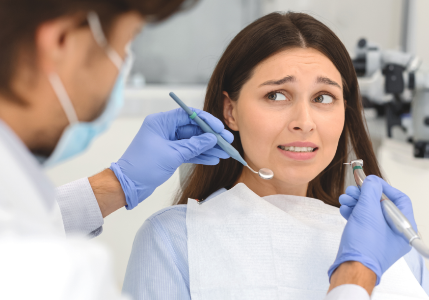 Patient in dental chair looking nervous